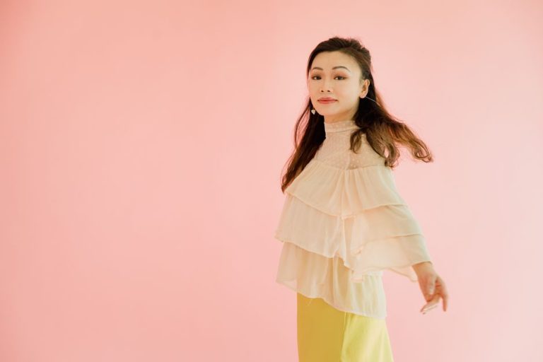Estilismo de gala con chaqueta militar beige, blusa bordada y falda satinada rosa