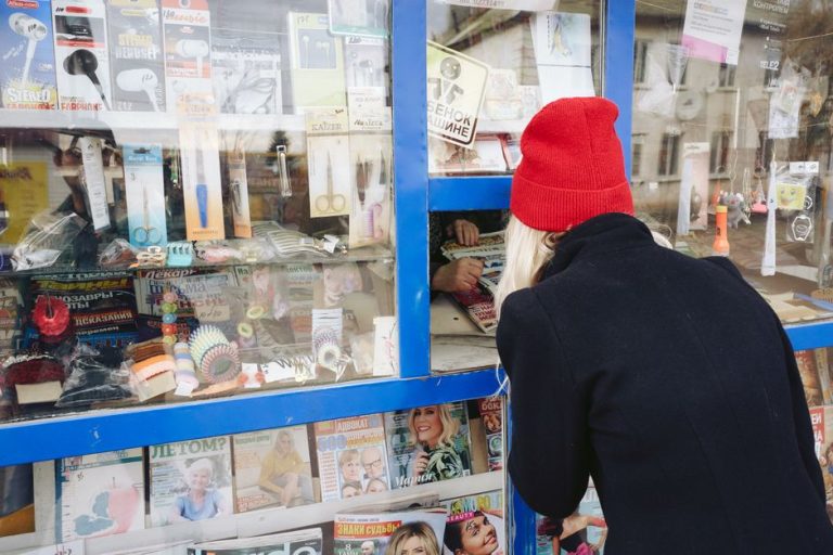 Revistas apiladas en expositor de quiosco