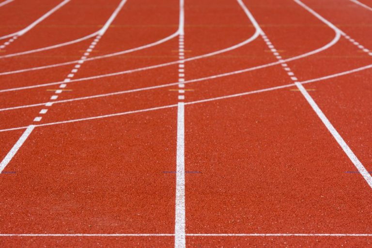 Imagen ilustrativa de una pista de atletismo vacía con carriles marcados