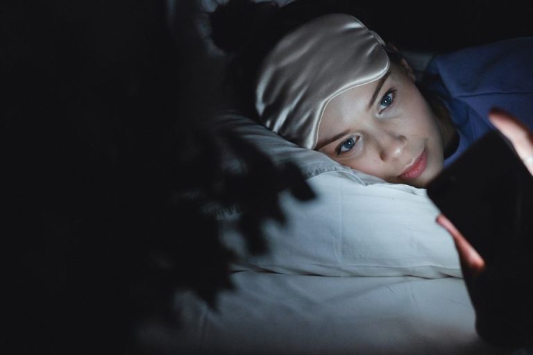 Mujer durmiendo de lado sobre almohada, concepto de cuidado facial nocturno y postura al dormir